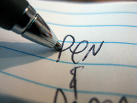 close up of a pencil writing pen on a paper