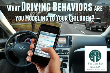 poster tittled "What driving behaviors are you modeling to your children?", and the picture of someone texting and driving