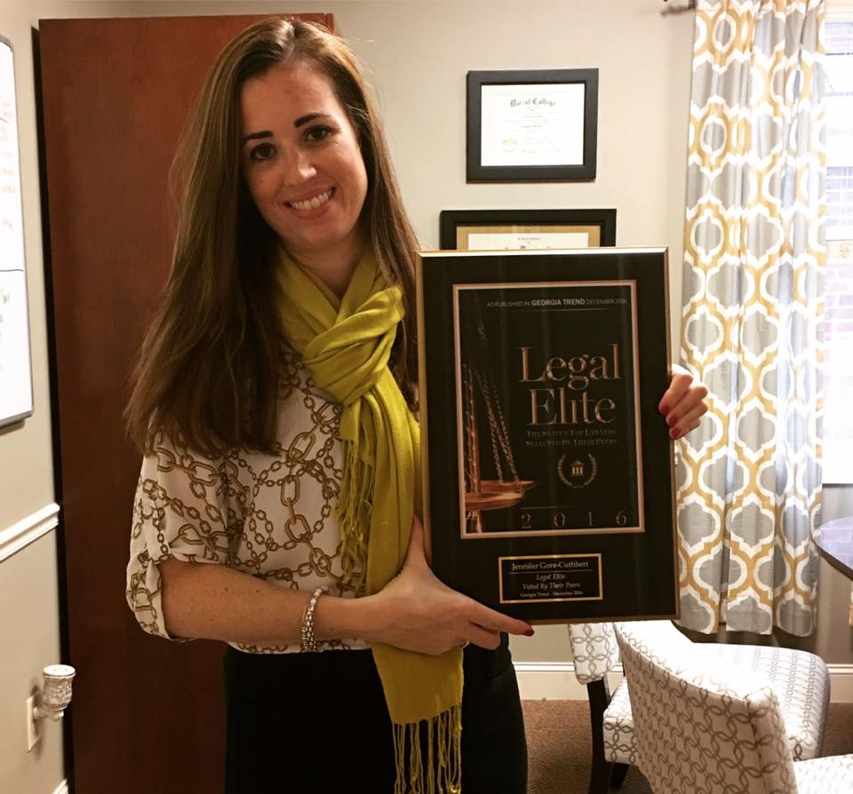 Jennifer holding an award of Legal elite