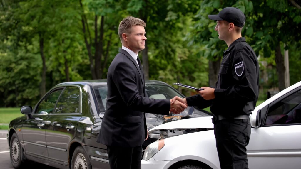 A civilian and a police officer exchanging information after a car accident in Georgia.